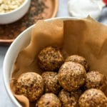 cookie dough balls in a container with brown paper