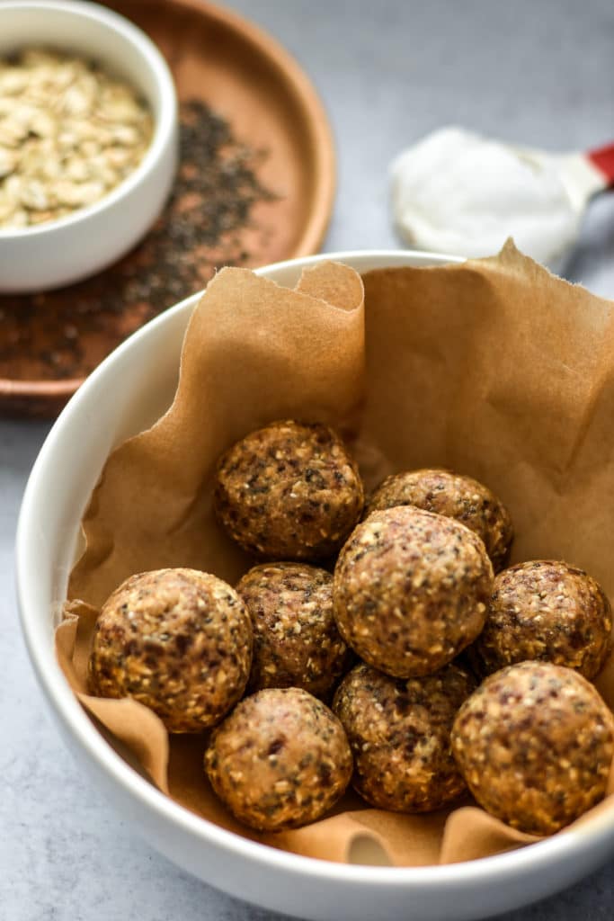 cookie dough balls in a container with brown paper
