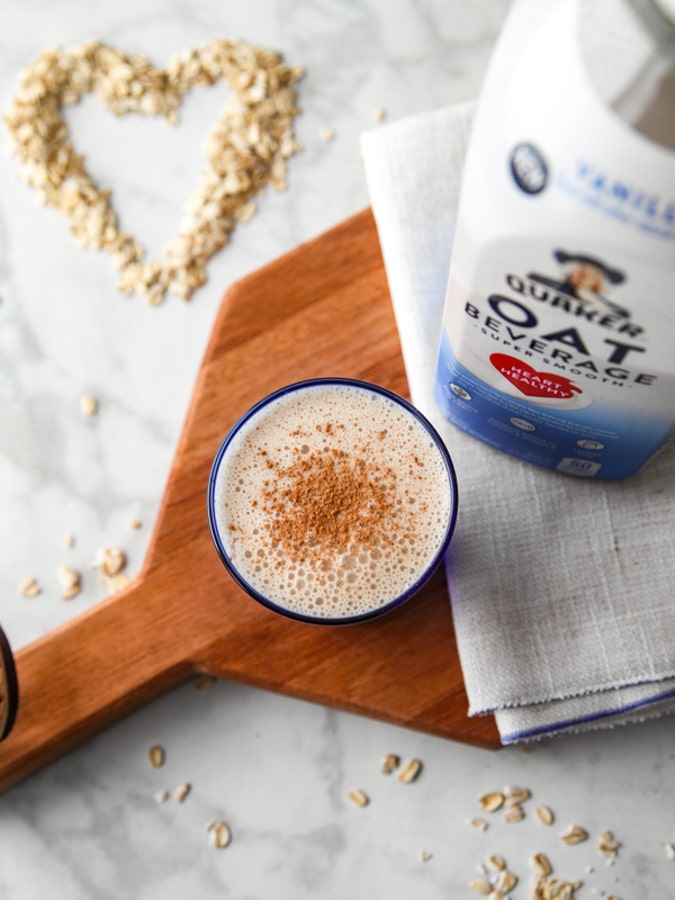 Snickerdoodle smoothie on a cutting board with oat milk