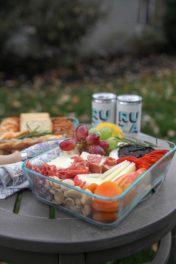 layers of cheese and fruit in a glass to-go container