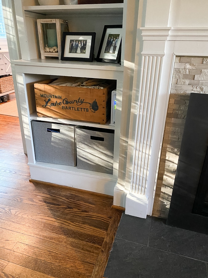White built-in shelves with neutral storage containers and decor. 