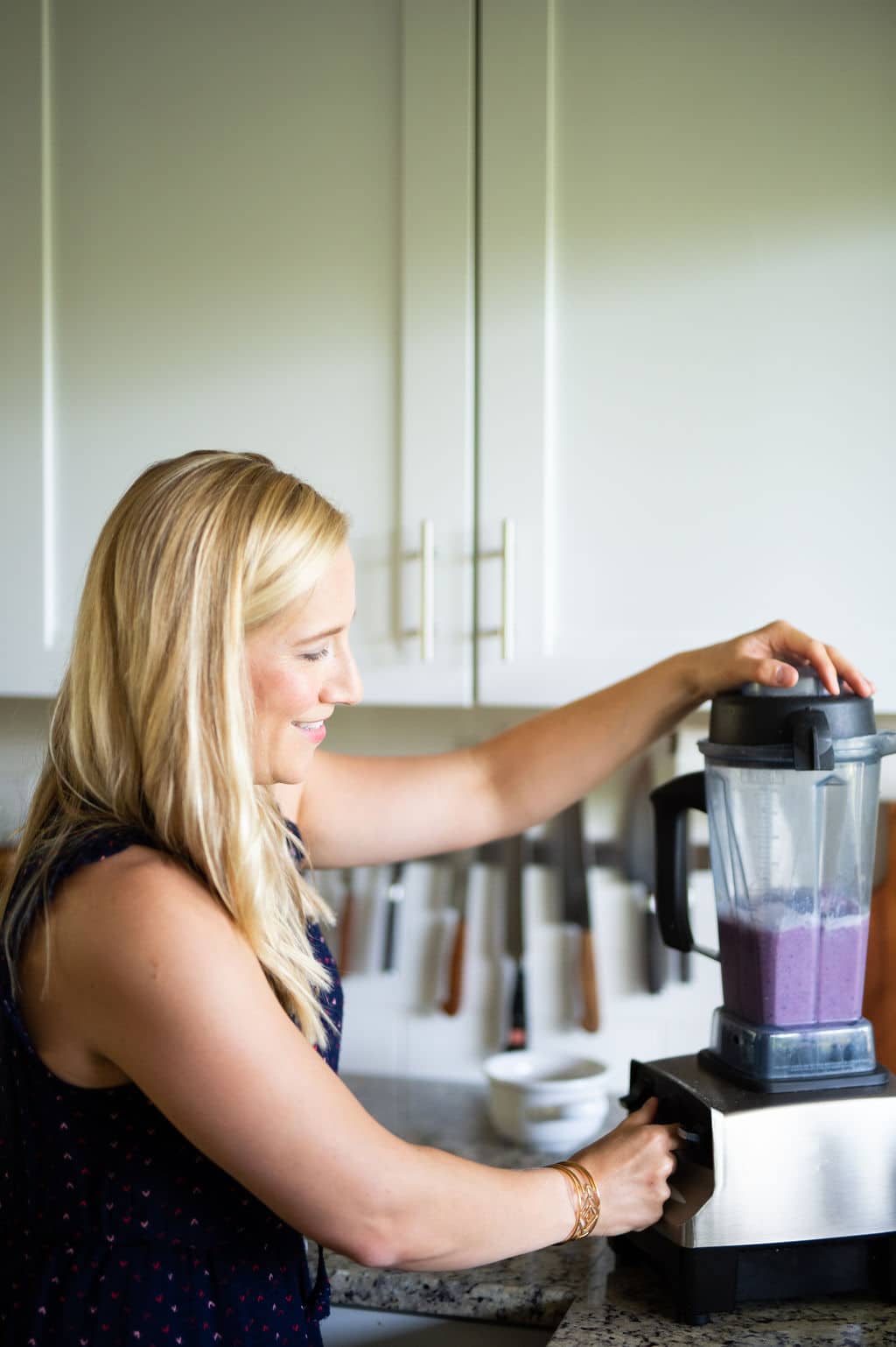 Kath blending a purple smoothie in a Vitamix. 