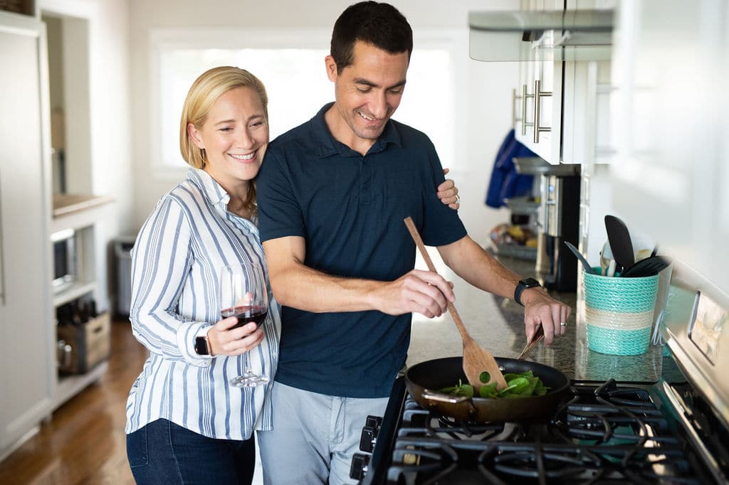kath and thomas cook blue apron in the kitchen