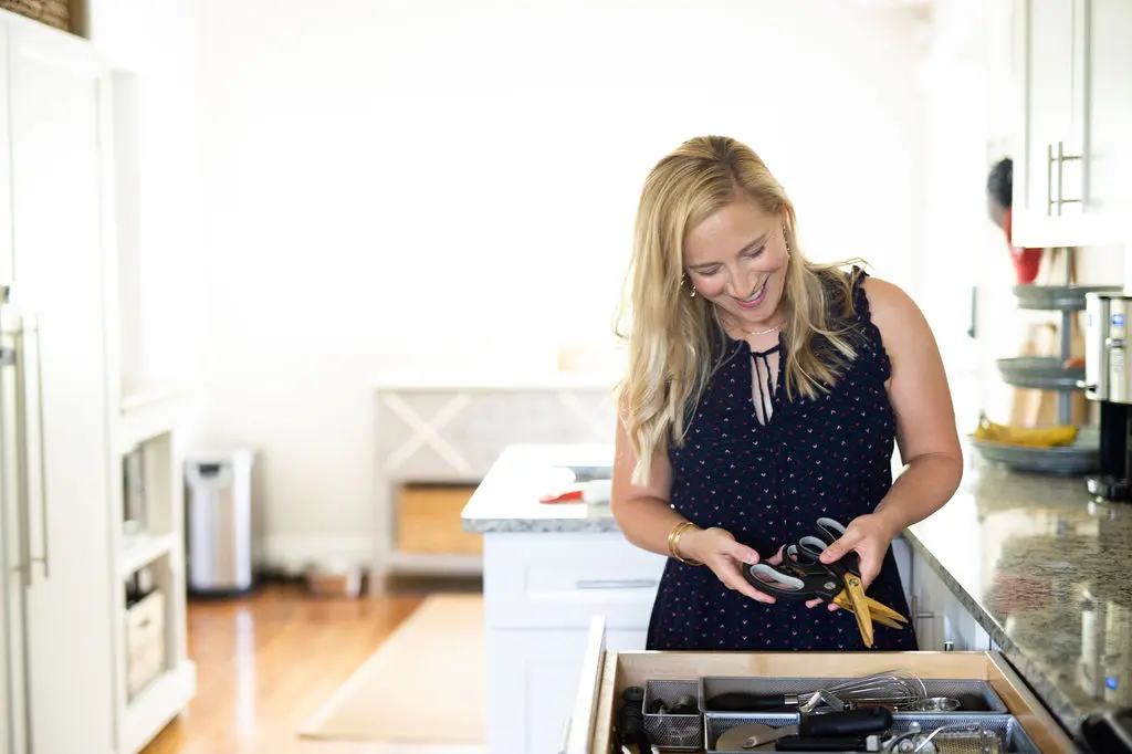 Kath Younger organizing kitchen drawers. 