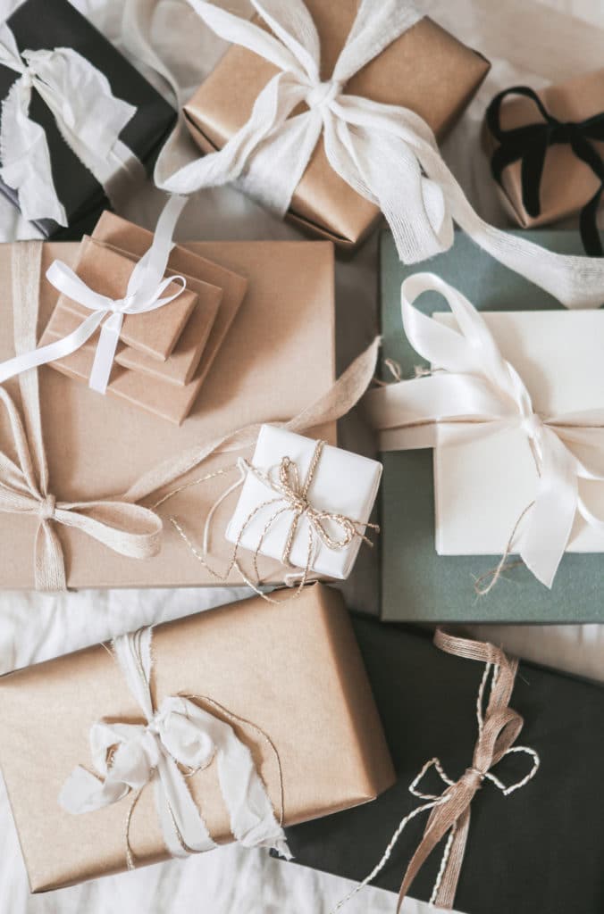 array of packages in cream and green with white ribbons