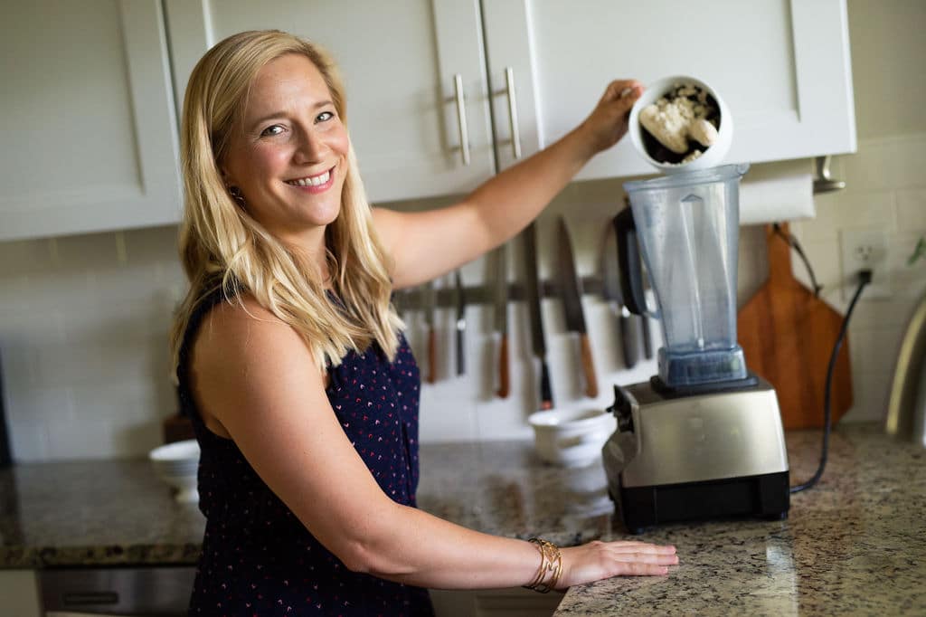 Kath putting smoothie ingredients in