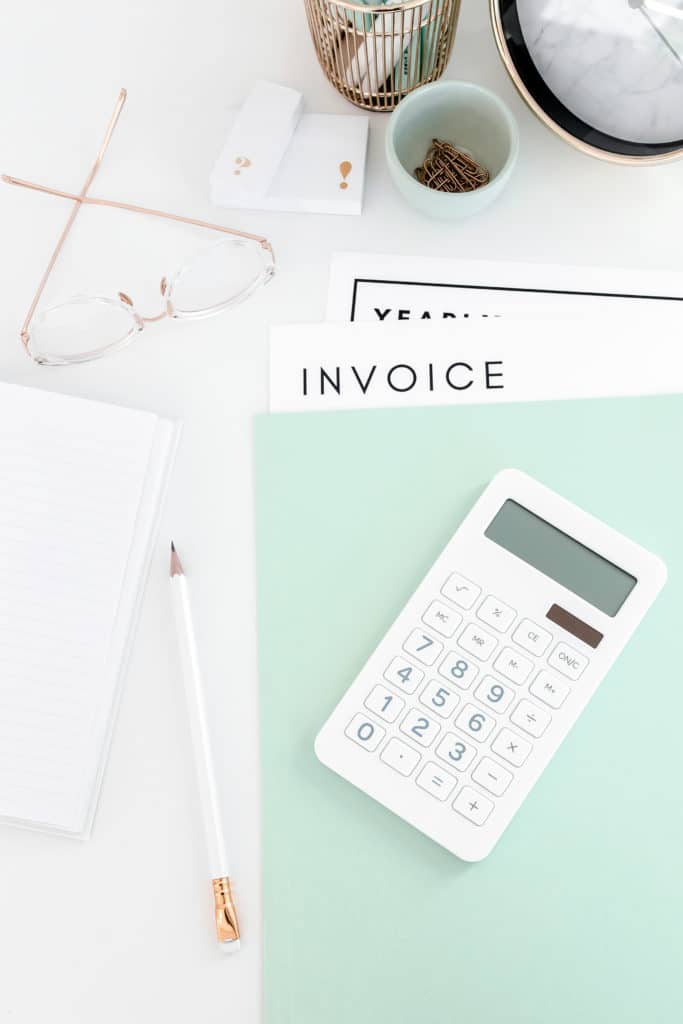 calculator and invoice on blue folder