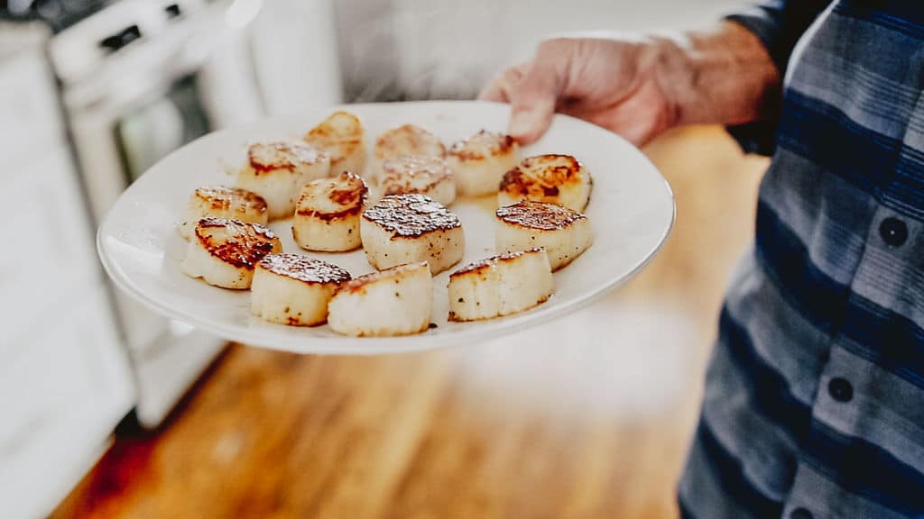 perfectly seared scallops on a plate