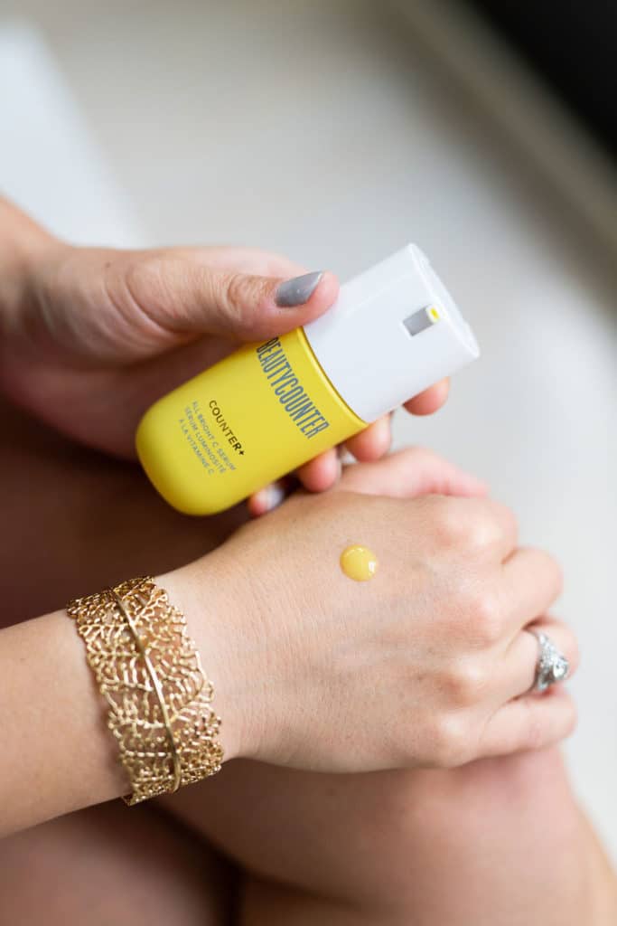 Beautycounter all bright c serum dot on hand with bottle