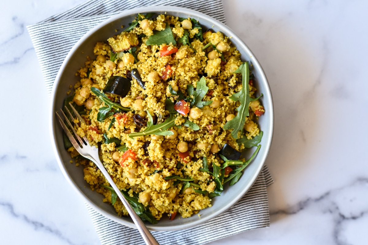 millet salad in a serving dish with fork