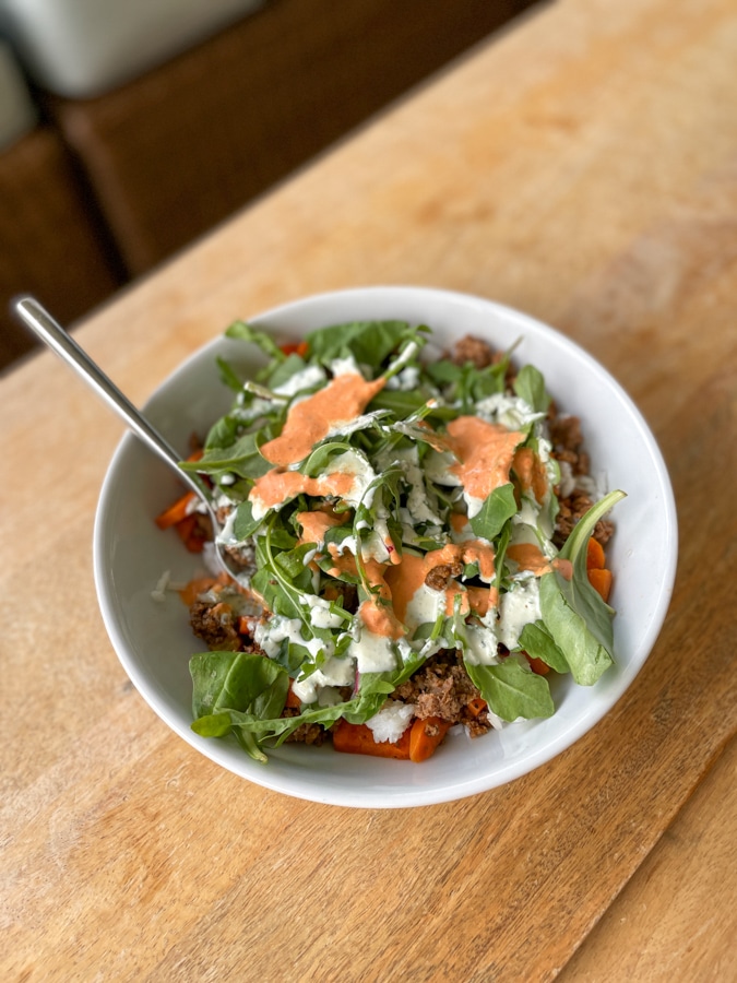 Leftover beef and veggies with salad on top and some Mezeh dressings