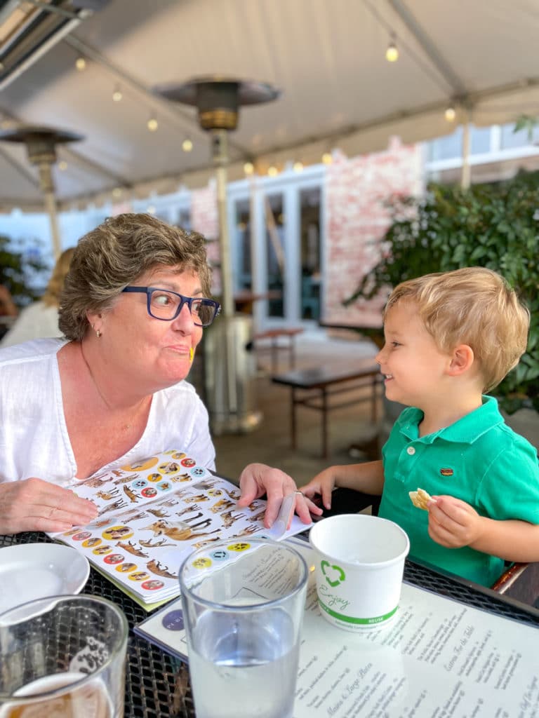 Birthday Dinner at Public | toddler giving stickers