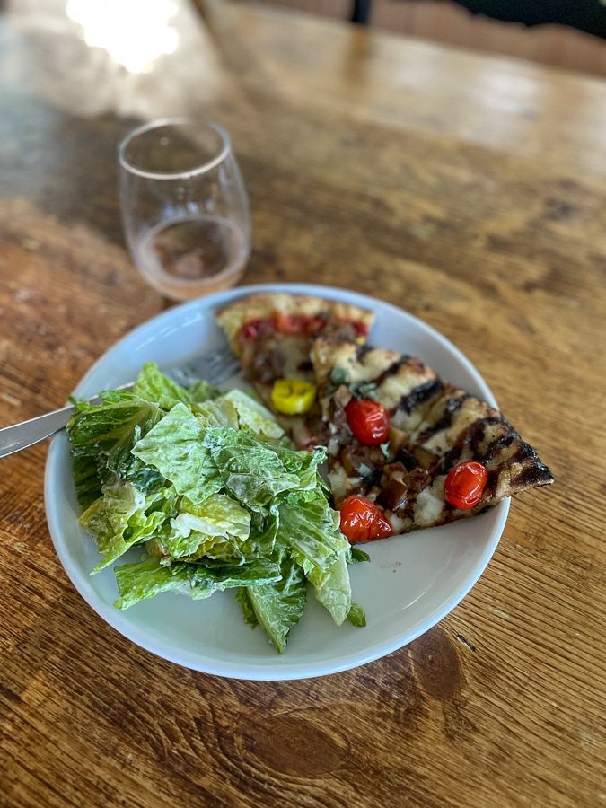 sausage pizza and an eggplant pizza