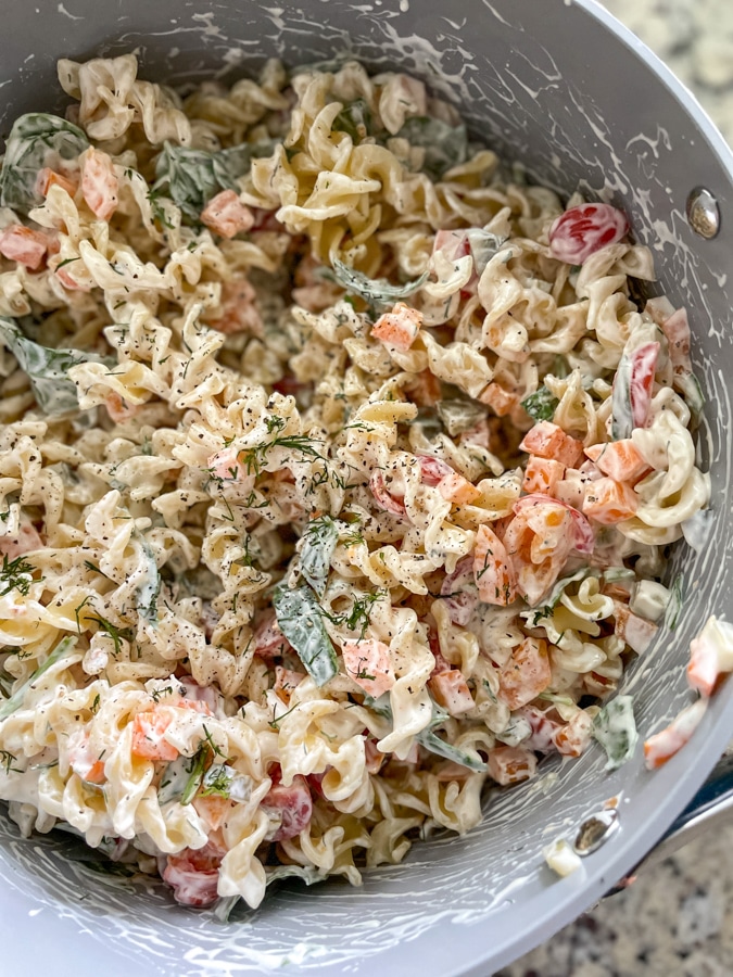 Season Dill Pickle Pasta Salad with salt and pepper