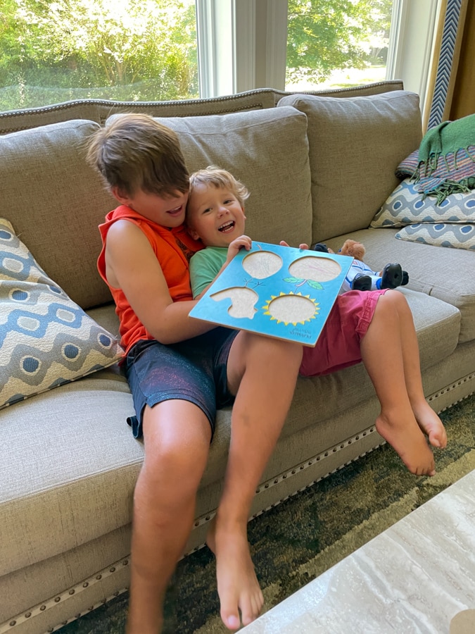 brothers playing in the couch