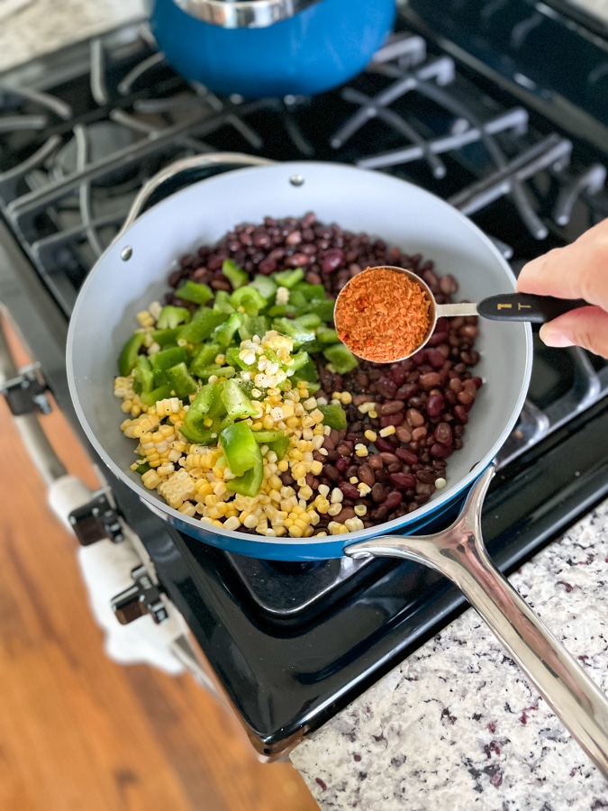 Sauté beans and veggies in pan