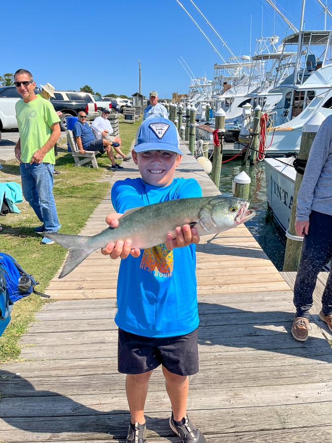 child holding fresh fish