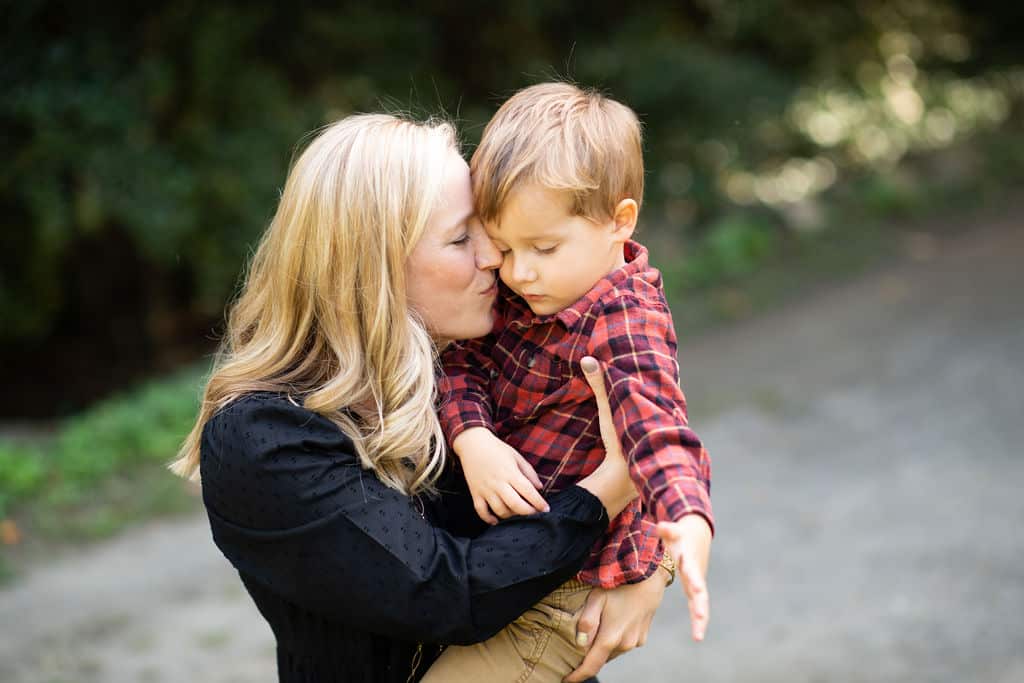 Mom kissing son