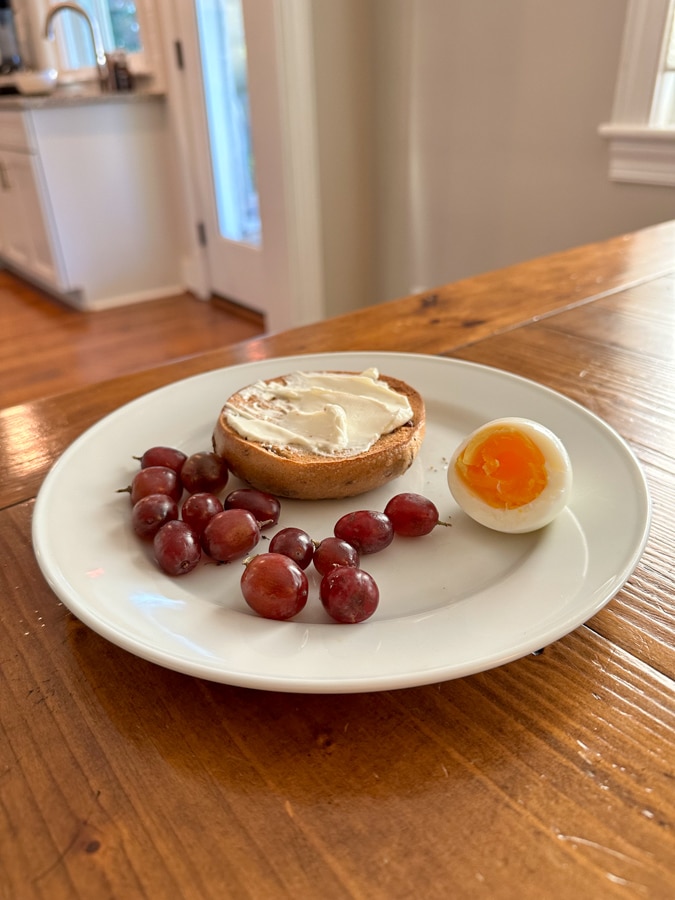 hard-boiled egg, grapes, and bagel