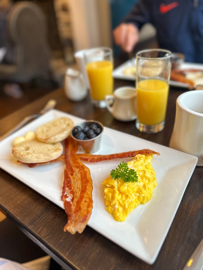 eggs, bacon, fruit, and a toasted English muffin