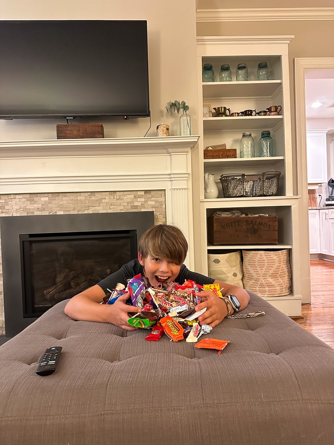 boy with pile of candy from trick or treating