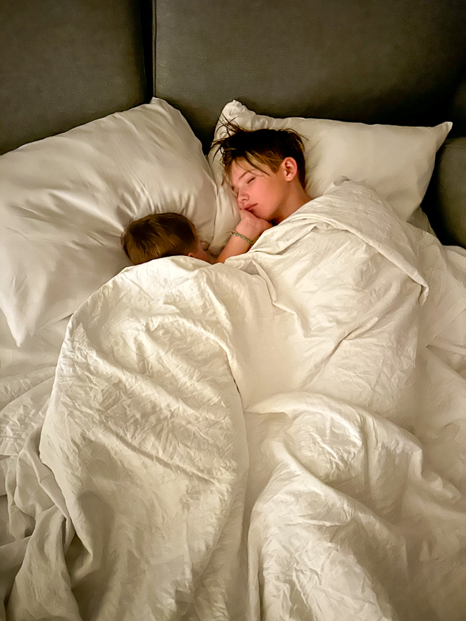 Brothers at hotel bed