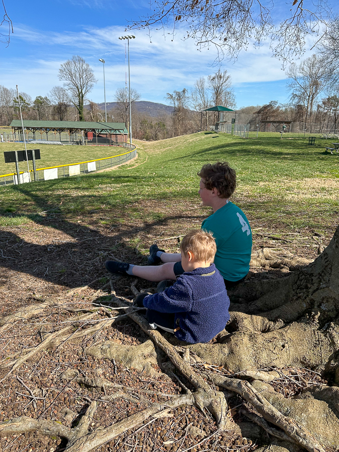 Watching baseball practice with cousin Nashie
