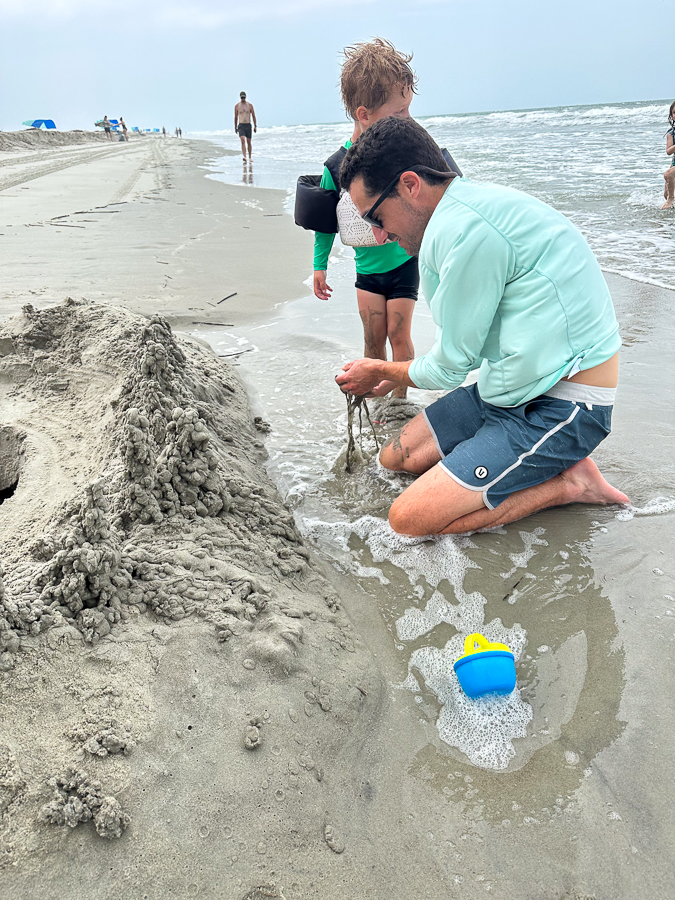 family playing in sand