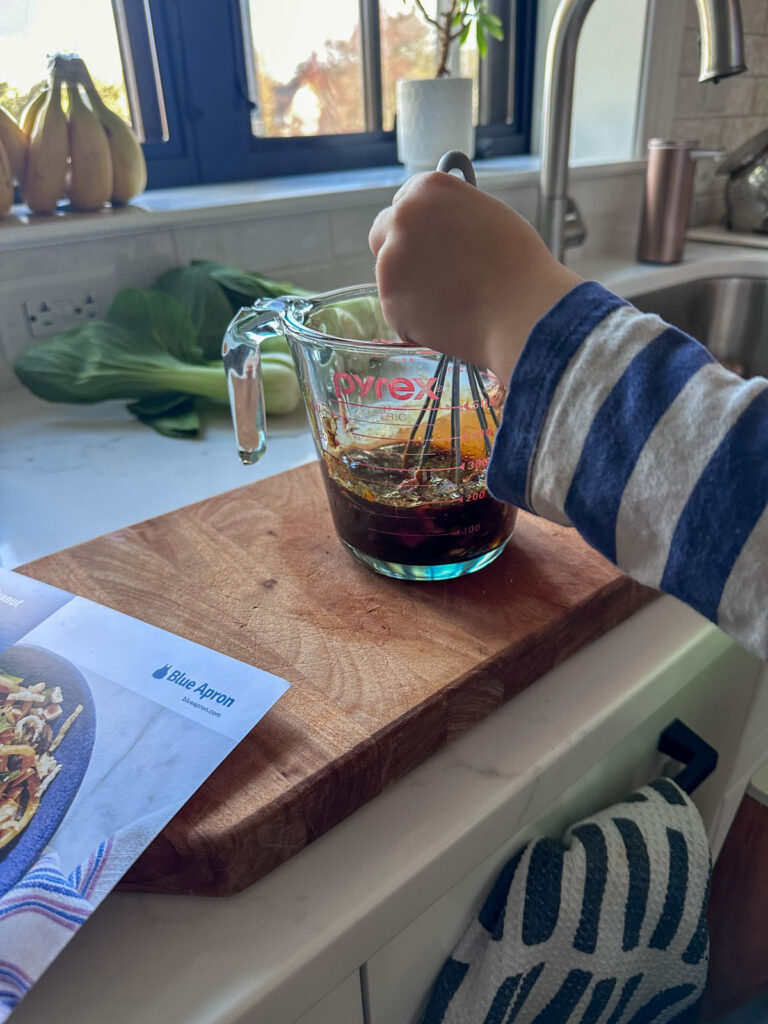 kid making peanut butter sauce