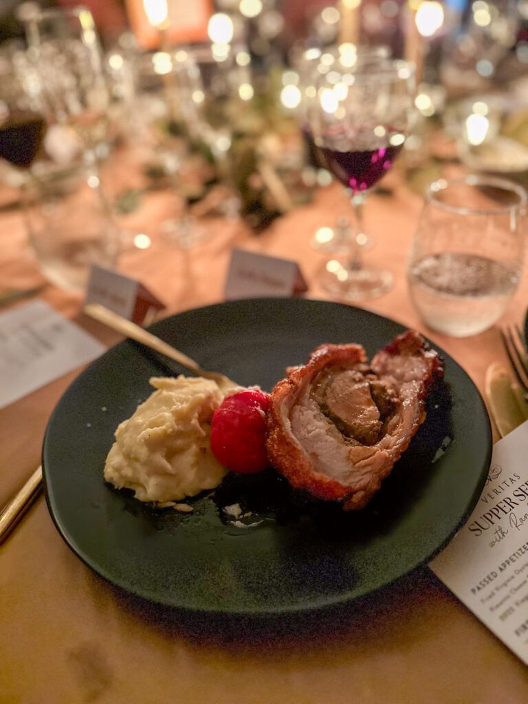 mashed potatoes, roasted tomatoes, and a porchetta