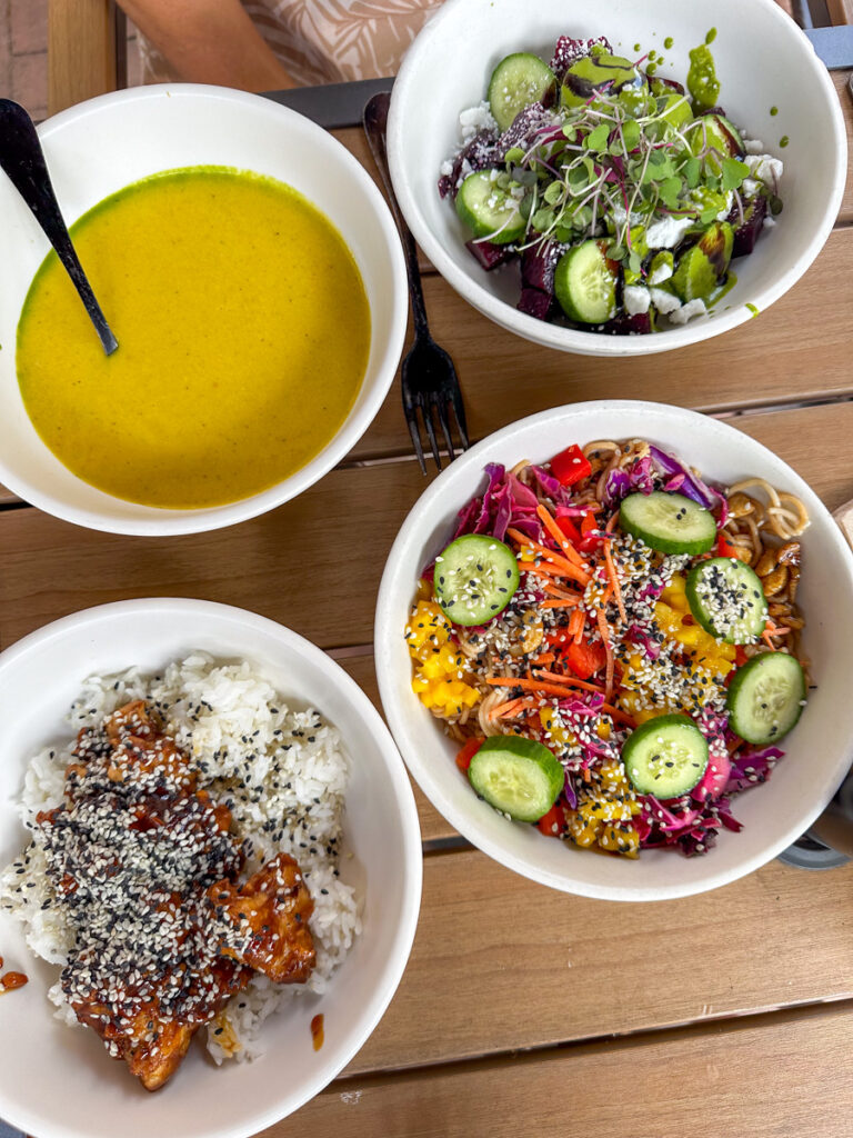 Kath Eats Blogger Kath Younger - in photo: a bowl of salad, rice bowl, and salad dressing