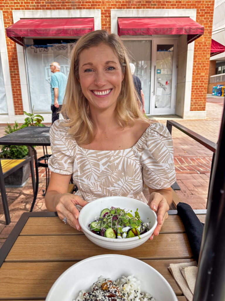 Kath Eats Blogger Kath Younger - in photo: woman holding a bowl of salad