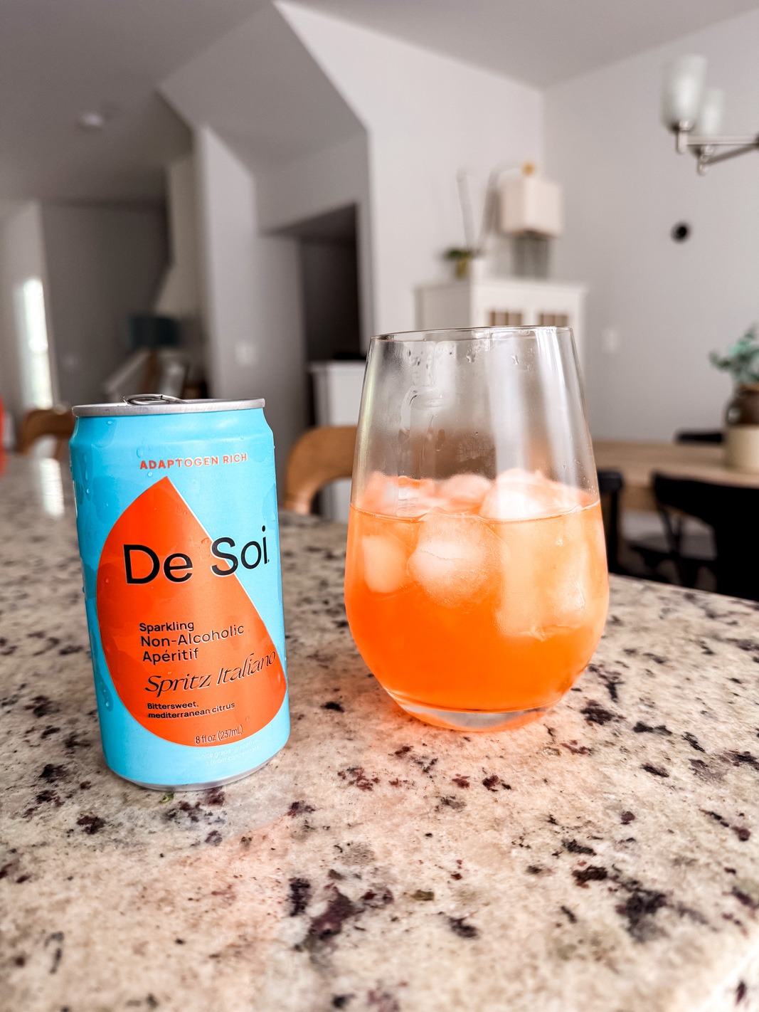 De Soi nonalcoholic aperol spritz can with some in an wine glass with ice
